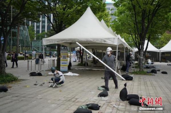 当地时间4月22日，韩国首尔市政府宣布位于首尔广场的临时核酸检测点终止运营，并于当日中午12时起开始拆除工作。 中新社记者 刘旭 摄